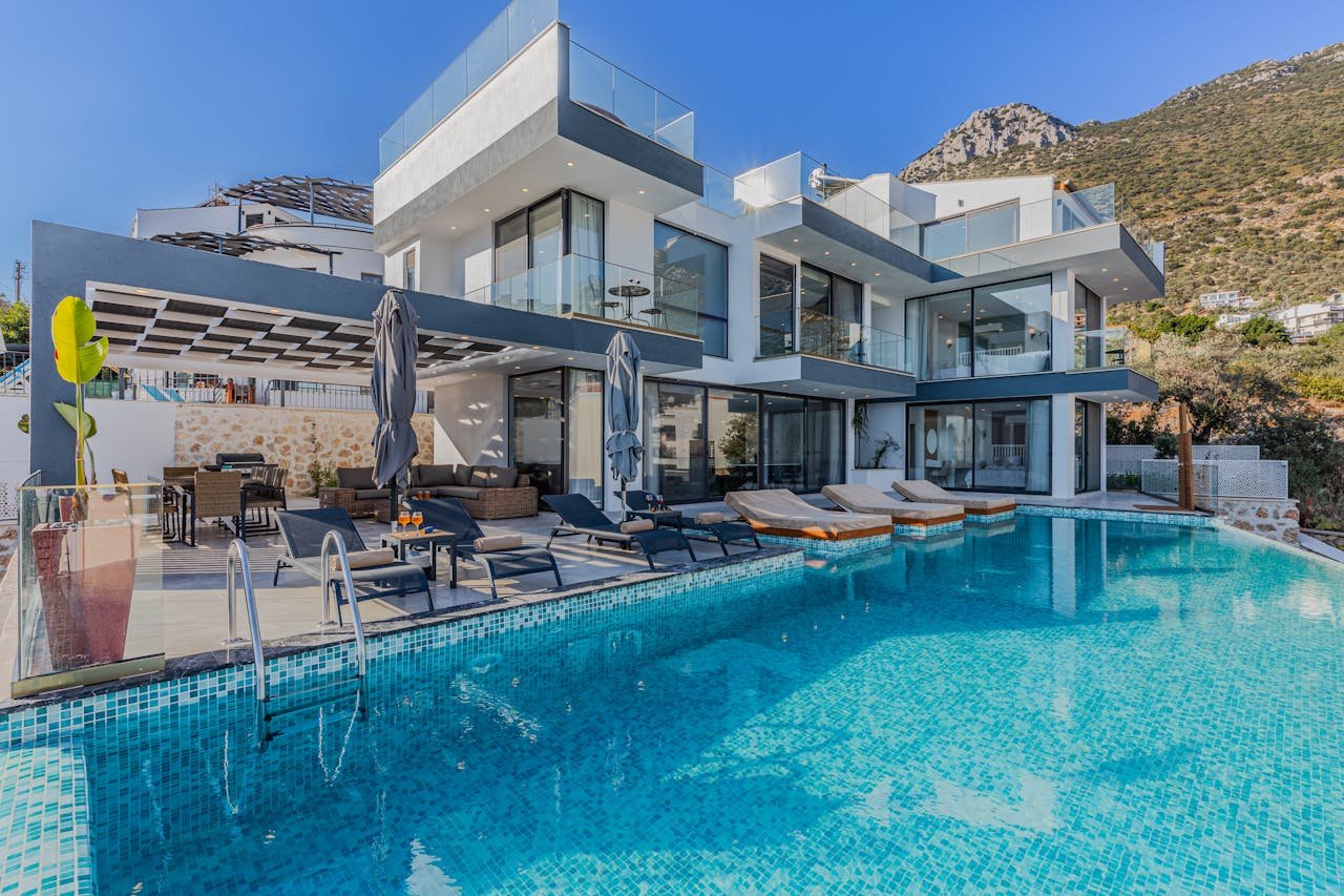 Stunning contemporary villa featuring a spacious infinity pool and breathtaking mountain backdrop.